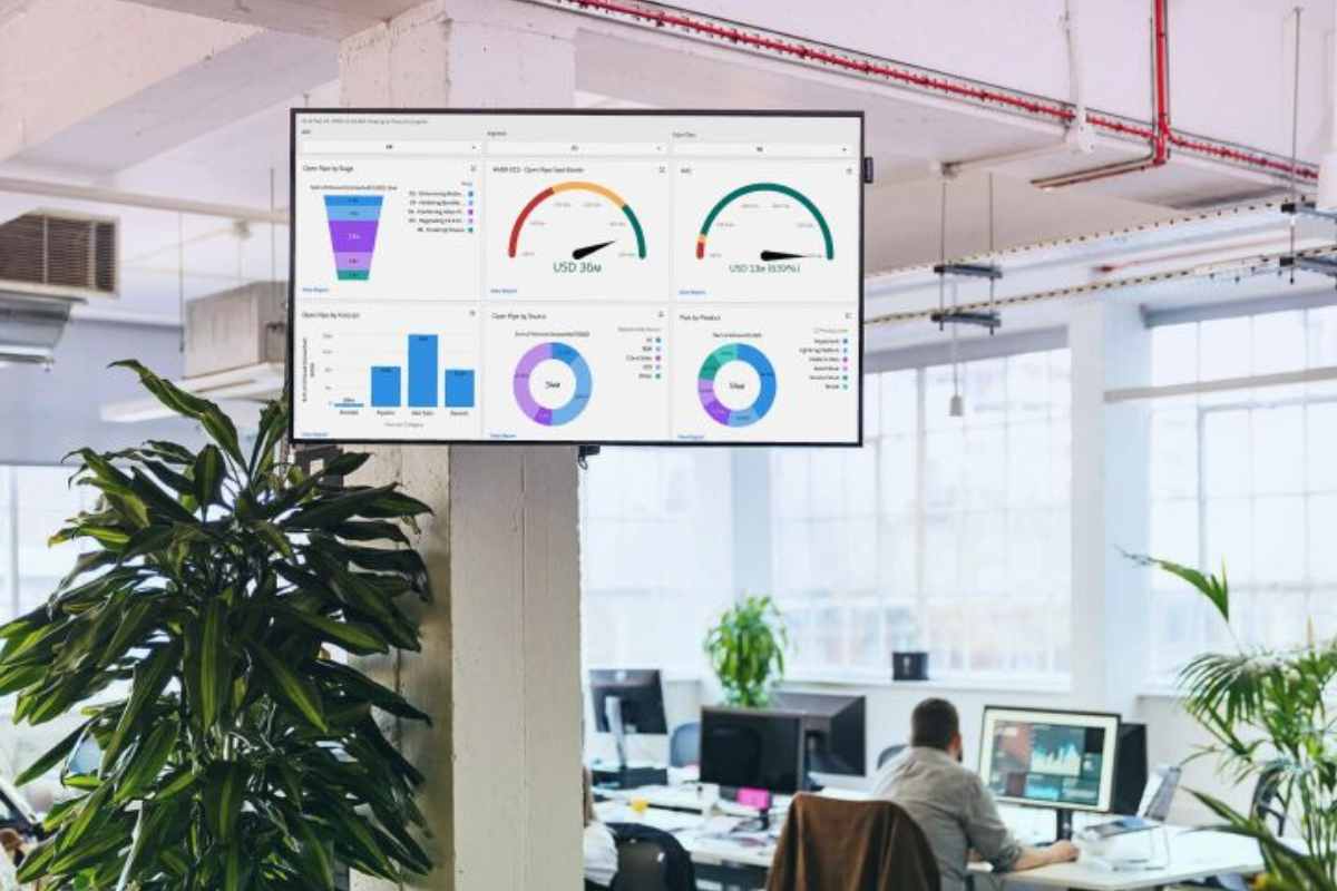 Business leaders reviewing digital dashboards and strategy in a modern enterprise office environment